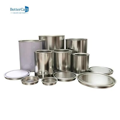 Pequeñas latas sin forro de la pintura alrededor de las latas vacías de la pintura del metal con las tapas